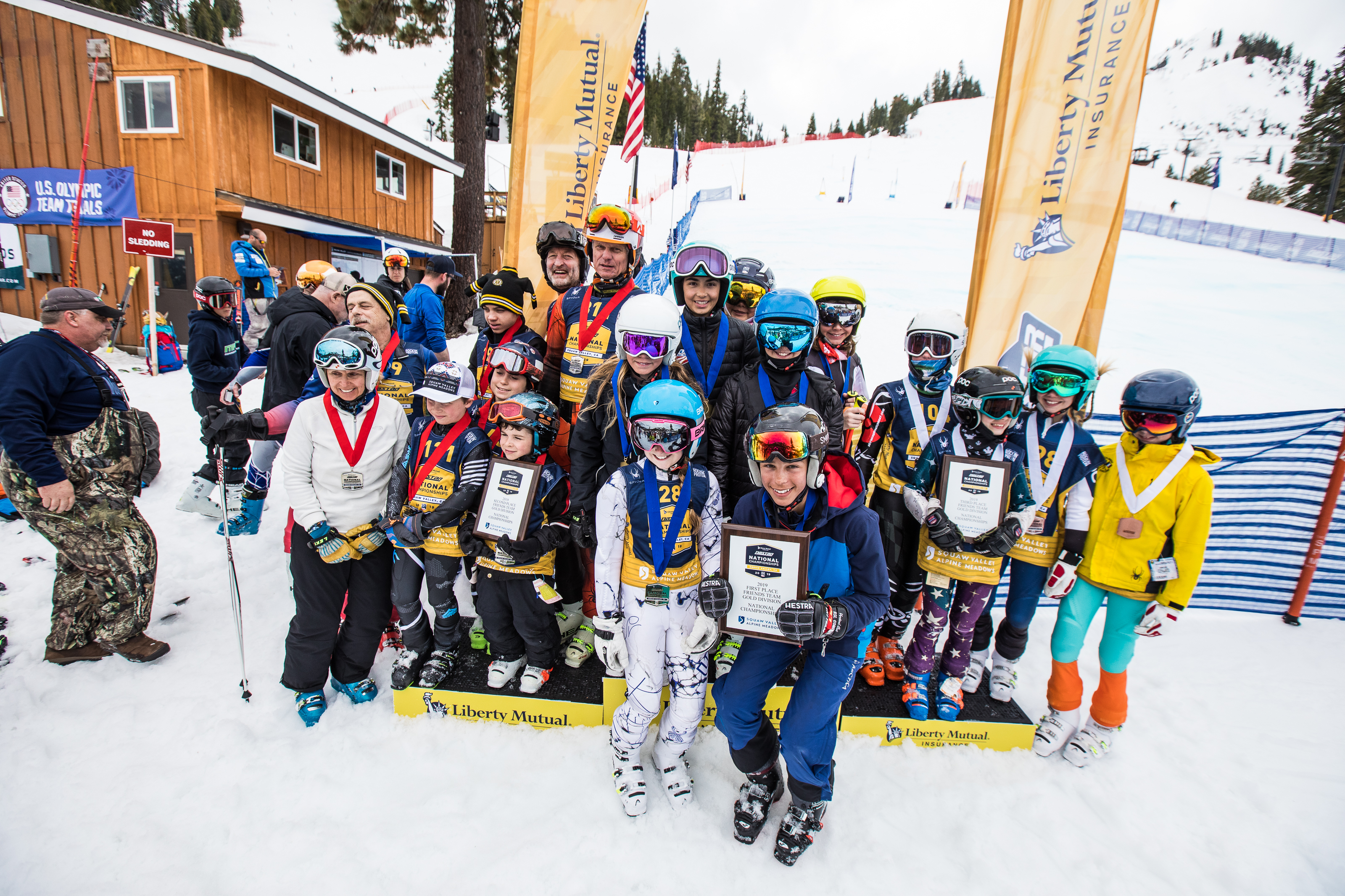 Friends Team Race Gold Division huddles together on the podium