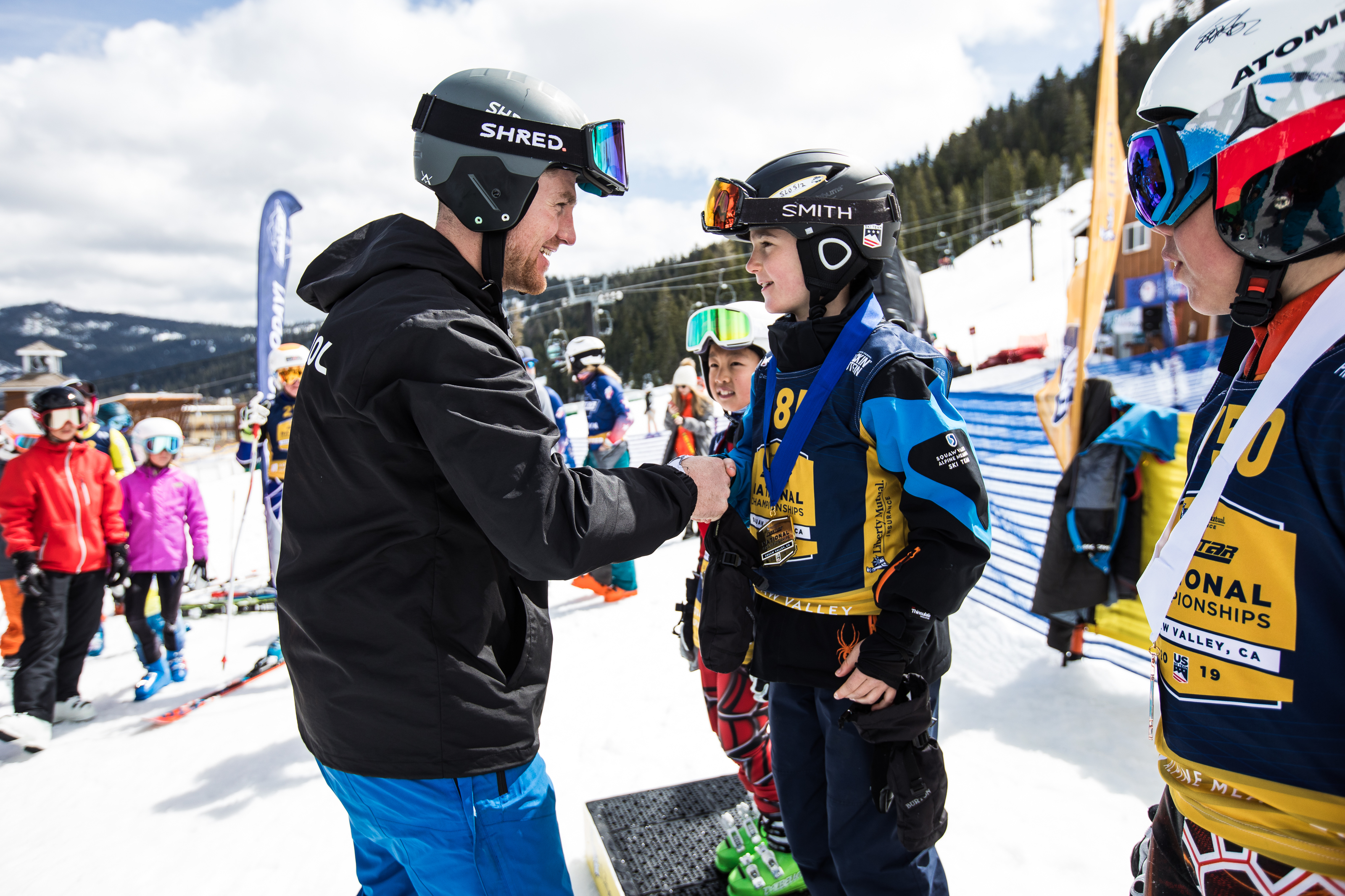 National Pacesetter and U.S. Ski Team member RCS hands out medals during Race of Champions